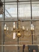 A LARGE TWELVE BRANCH BRASS CEILING LIGHT FITTING