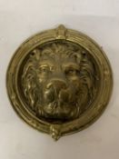 A SOLID BRASS LION HEAD DOOR KNOCKER