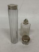 A CLEAR GLASS PERFUME BOTTLE WITH A HALLMARKED LONDON SILVER NECK TOGETHER WITH A GLASS JAR WITH A