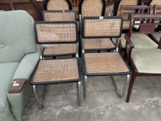 FOUR BLACK ASH EFFECT DINING CHAIRS ON CHROME TUBULAR FRAMES WITH CANE SEATS AND BACKS