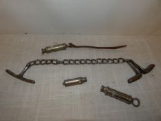 A VICTORIAN SET OF POLICE HANDCUFFS AND THREE WHISTLES