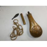 A 19TH CENTURY COPPER AND BRASS POWDER FLASK, THE BODY WITH HUNTING SCENE DECORATION, GUN CLEANING