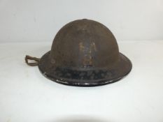 A WORLD WAR II BRITISH PAINTED STEEL HELMET AND LINER, THE HELMET BEARS PAINTED DECORATION, FA8