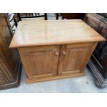 A LOW PINE TWO DOOR CUPBOARD, 31" WIDE