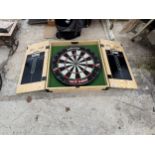 A UNICORN BRISTLE DARTBOARD WITH CABINET AND A SET OF DARTS
