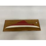 A MAHOGANY WALL PLAQUE WITH THE HULL OF A BOAT, 20" X 7"