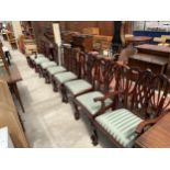 A SET OF EIGHT CHIPPENDALE STYLE DINING CHAIRS WITH RIBBON BACKS ON CABRIOLE FRONT LEGS AND BALL AND