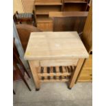 A KITCHEN WORK TABLE ON CASTORS ENCLOSING TEN BOTTLE WINE RACK