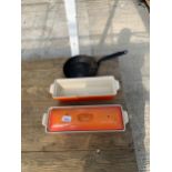 A LE CREUSET CAST IRON LIDDED BREAD OVEN DISH TOGETHER WITH A SIMILAR DISH AND A SMALL CAST IRON