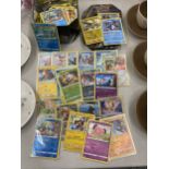A TIN OF POKEMON CARDS TO INCLUDE SHINIES, ETC