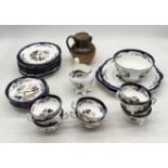 A Royal Stafford part tea set decorated with Chinese style traditional scenes along with a Doulton