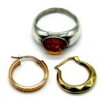 Two 9ct gold earrings (1g) along with silver ring set with amber.