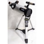 A Celestron 114LCM computerised telescope on tripod, untested - Overall size height 87cm, diameter
