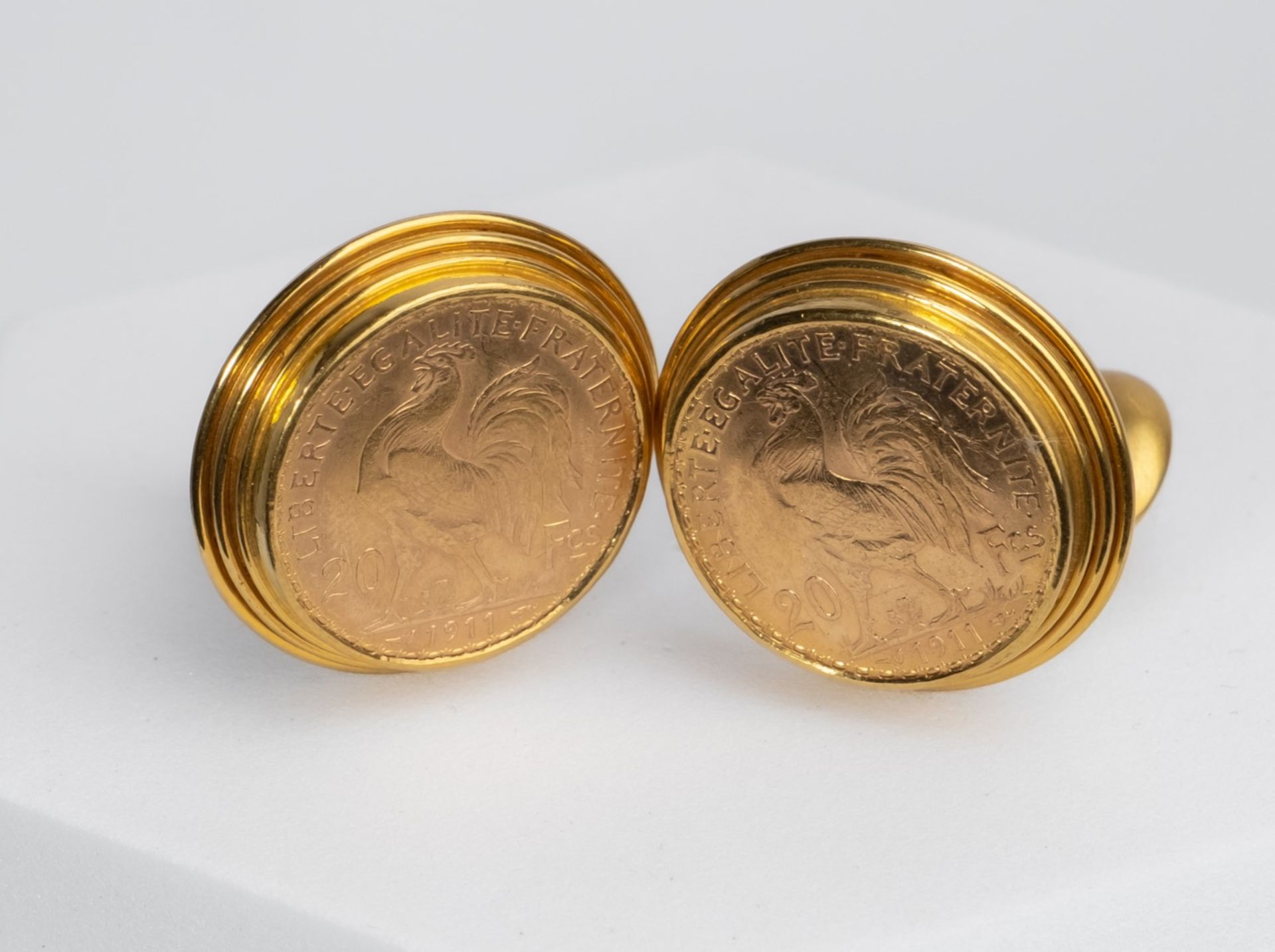 Paar Manschettenknöpfe, 18kt Gelbgold, 2 Münzen 20 Francs 1911 Gallischer Hahn, zus. ca. 35.5 g