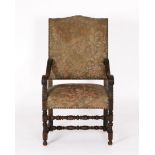 Armlehnsessel im Stil des Barock, wohl um 1900, Nussbaum geschnitzt, volutierende Armlehnen, allsei