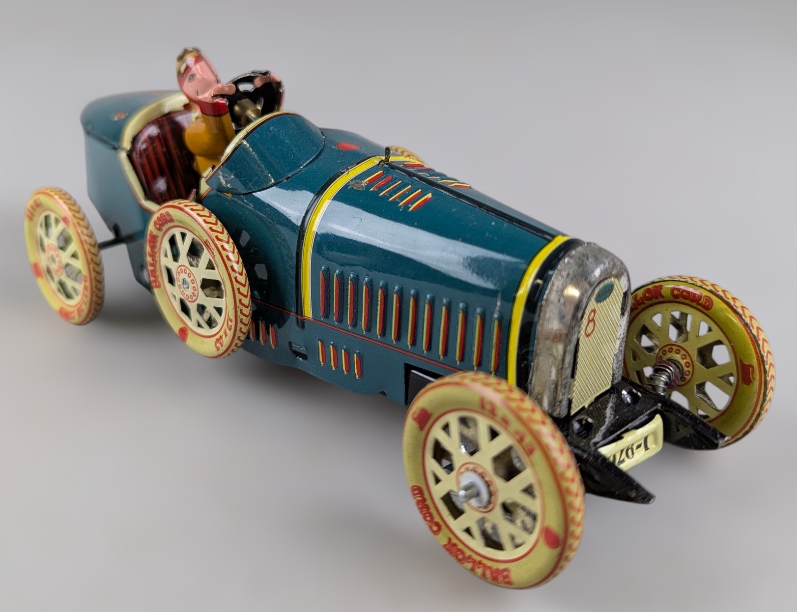 A tinplate clockwork racing car modelled as a Bugatti Type 35A, with ...