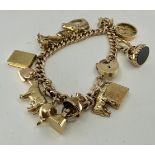 A 9ct rose gold charm bracelet, with fifteen gold charms to include; a "9 375" hallmarked cow charm,