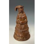 A 19th century Brampton type salt glaze figure, lady in dress with muff, 17cm high overall, c. 1850