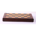 A George IV mahogany and parquetry rectangular folding chess board, the box interior inlaid for