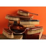 A George V silver and tortoiseshell dressing table set, comprising a hand mirror, pairs of hair