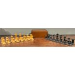 An English boxwood and ebonised Staunton pattern chess set, unweighted, the Kings 7cm high, mahogany