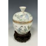 A 19th century Chinese porcelain cup and cover on stand, decorated with goji in garden settings,