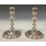 A pair of 18th century Italian cast silver candlesticks, knopped pillars, fluted sconces and