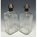 A pair of Victorian silver 'medicine bottle' decanters, cut level indicator notches, conical