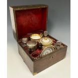 A 19th century brass bound mahogany travelling picnic set, hinged cover enclosing a silver plated