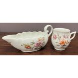 An 18th century Derby sauceboat of fluted form and with scrolling handle, painted in coloured