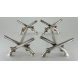 A pair of unusual Elizabeth II silver novelty knife rests, of arms and armour interest, the ends