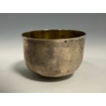 An early George III silver tumbler cup, quite plain, gilt interior, 6cm diam, London 1764, 65g