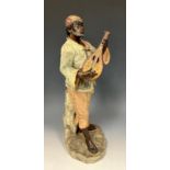 A 19th century Orientalist terracotta figure, North African man playing mandolin, in the style of