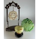 A Chinese soapstone gong, pierced with shou longevity symbol, hardwood stand, 20cm high overall; a