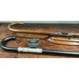 An early 20th century novelty fishing rod walking stick, the collar mounted with reel, the screw