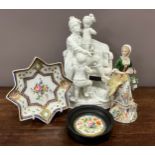 A Mid 19th century Meissen biscuit porcelain group of a man and two children on a settee, incised