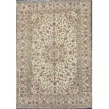 A Persian Kashan rug with multi-lobed central medallion. Featuring ruby red, midnight blue and ivory