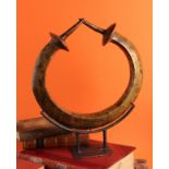 Tribal Art - a Yoruba bronzed metal torque or manilla, Nigeria, 35cm wide, on stand
