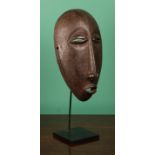 Tribal Art - an African hardwood mask, probably Hemba, of slender oval form, narrow eyes, projecting