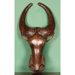 Tribal Art - a Bamileke hardwood zoomorphic mask, carved as a stylised buffalo head, 93cm long,
