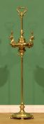 A brass two-light floor lamp, posted handle, the lamp supports cast as birds, shaped circular