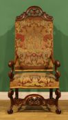 A William & Mary Revival walnut armchair, stuffed-over upholstery, shaped and pierced cresting,