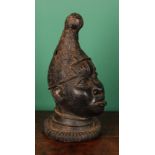 Tribal Art - a Benin bronze, cast as the head of an Oba or figure of the court, 42cm high, Nigeria