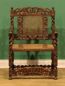 A Charles II Revival oak armchair, carved with a crown, acanthus and flowerheads bosses, 91cm