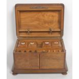 A Victorian walnut rounded rectangular games compendium, hinged cover above a pair of doors