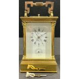 A French brass carriage clock, with key and instructions