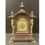 A Junghans arched top bracket clock, silvered chapter ring with Arabic numerals, twin winding holes,