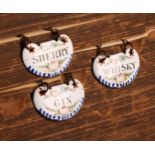 A set of three 19th century enamel cartouche shaped wine labels, Gin, Sherry and Whisky, decorated