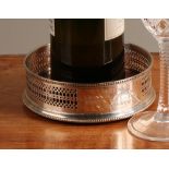 An Elizabeth II silver magnum wine coaster, pierced gallery, turned base, 14cm diameter, John Bull