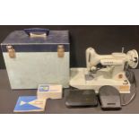 A Singer featherweight sewing machine, model 221k, instruction manual and singer sewing machine